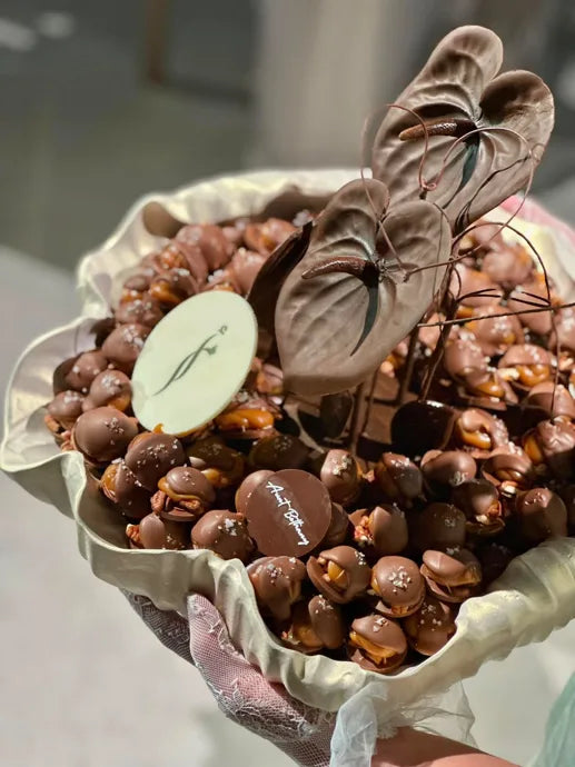 Sculpted chocolate leaves and a carefully arranged chocolate assortment